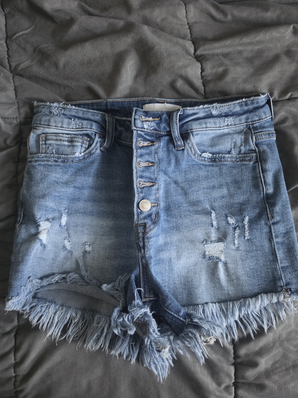 High-Rise Distressed Denim Shorts in Light Blue